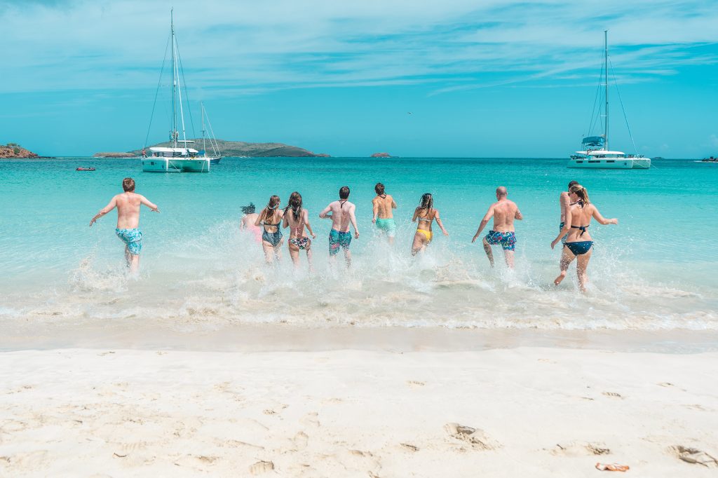 Spring Break Beach folks jumping in water 2023