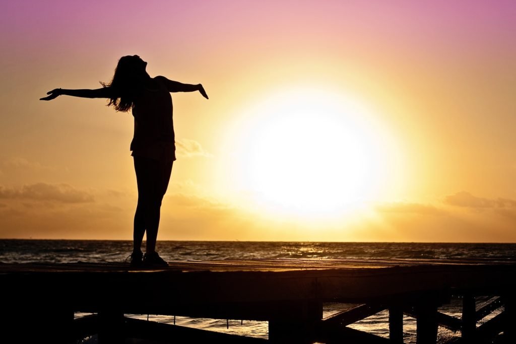 women silhouetted in sun